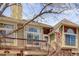 Exterior of the townhome showing a unit entrance and a wooden deck area at 1885 S Quebec Way # D22, Denver, CO 80231