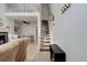 Bright and airy living room with stairs to loft area, carpeted stairs, and minimalist decor at 1885 S Quebec Way # D22, Denver, CO 80231