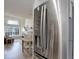Stainless steel refrigerator in dining area connected to the brightly lit living room at 1885 S Quebec Way # D22, Denver, CO 80231
