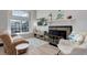 Bright living room features a large window, fireplace, wood floors, and comfortable seating at 1885 S Quebec Way # D22, Denver, CO 80231