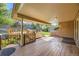 Inviting back deck with a built-in outdoor grill, wooden railings, and a covered area at 6708 W Portland Ave, Littleton, CO 80128