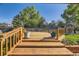 Wooden back deck overlooking a lush, well-maintained yard with mature trees, green grass, and a playhouse at 6708 W Portland Ave, Littleton, CO 80128