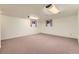 Finished basement with neutral carpet, two windows, and recessed lighting at 6708 W Portland Ave, Littleton, CO 80128