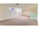 Spacious basement with neutral carpet, a small window, and light green doors at 6708 W Portland Ave, Littleton, CO 80128