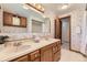 Bathroom featuring a double vanity, with tile flooring and classic wallpaper at 6708 W Portland Ave, Littleton, CO 80128