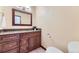 Bathroom featuring a wooden vanity with granite countertop and a modern toilet at 6708 W Portland Ave, Littleton, CO 80128