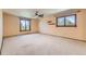 Spacious bedroom with carpet flooring, ceiling fan, and windows providing natural light at 6708 W Portland Ave, Littleton, CO 80128