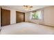Bedroom with carpet, window with white curtains, ceiling fan, and closet at 6708 W Portland Ave, Littleton, CO 80128