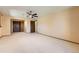 Large bedroom with carpet flooring, ceiling fan, and double door closet at 6708 W Portland Ave, Littleton, CO 80128