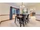 Classic dining room featuring a dark wood table, leather chairs, a window, and neutral decor for elegant meals at 6708 W Portland Ave, Littleton, CO 80128