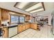 Kitchen featuring a garden window, wood cabinets, and a view into the adjacent living area at 6708 W Portland Ave, Littleton, CO 80128