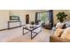 Bright and airy living room featuring a neutral color scheme, large windows, and comfortable seating arrangements at 6708 W Portland Ave, Littleton, CO 80128