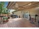A cozy covered back deck, perfect for outdoor entertaining with stylish lighting and space for grilling and exercise equipment at 5428 Suffolk Ave, Castle Rock, CO 80104