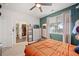 A comfortable bedroom features a ceiling fan, natural light, and a view to an organized walk-in closet at 5428 Suffolk Ave, Castle Rock, CO 80104