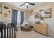 A charming baby Bedroom decorated with a Western theme, complete with a crib, chair, and wooden accents at 5428 Suffolk Ave, Castle Rock, CO 80104