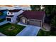 Exterior view of home at dusk featuring a manicured lawn, neutral paint and traditional architectural details at 5428 Suffolk Ave, Castle Rock, CO 80104
