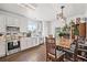 This well-lit kitchen features ample counter space, white cabinets, and a cozy dining area at 5428 Suffolk Ave, Castle Rock, CO 80104
