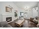 Cozy living room featuring a fireplace, built-in shelving, and an open layout at 5428 Suffolk Ave, Castle Rock, CO 80104