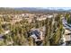 Birds-eye view showcasing a modern home with solar panels surrounded by mature trees at 3064 Elk View Dr, Evergreen, CO 80439