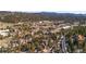 Community aerial view showcasing homes and commercial properties amidst the trees in the background at 3064 Elk View Dr, Evergreen, CO 80439
