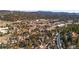 Elevated view of homes set among mature trees near local shopping centers at 3064 Elk View Dr, Evergreen, CO 80439