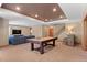 Finished basement with a pool table, bar, and sectional couch at 3064 Elk View Dr, Evergreen, CO 80439