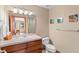 Well-lit bathroom featuring a vanity with wooden drawers, a large mirror, and modern fixtures at 3064 Elk View Dr, Evergreen, CO 80439