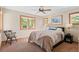 Bedroom featuring a bed, chair and two windows at 3064 Elk View Dr, Evergreen, CO 80439