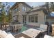 Outdoor deck and patio, complete with outdoor furniture, a grill and views of the surrounding wooded area at 3064 Elk View Dr, Evergreen, CO 80439