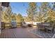 Back deck featuring outdoor seating, a grill and a fire pit, perfect for entertaining or relaxing in nature at 3064 Elk View Dr, Evergreen, CO 80439