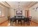 Elegant dining room featuring hardwood floors and a stylish chandelier, perfect for hosting gatherings at 3064 Elk View Dr, Evergreen, CO 80439