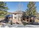 Inviting two-story home featuring a stone facade, covered porch, and a three-car garage with solar panels at 3064 Elk View Dr, Evergreen, CO 80439