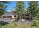 Expansive home exterior with a three-car garage, solar panels, and a inviting front porch at 3064 Elk View Dr, Evergreen, CO 80439