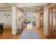 Elegant foyer with hardwood floors and views into the living room with large windows at 3064 Elk View Dr, Evergreen, CO 80439