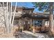 Charming home entrance with stone pillars, covered porch, and elegant wooden door at 3064 Elk View Dr, Evergreen, CO 80439