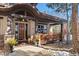 Charming front porch with wood columns, stone accents, and a cozy seating area, number 3064 visible at 3064 Elk View Dr, Evergreen, CO 80439