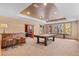 Spacious game room with a rustic bar, pool table, and large windows offering natural light and views at 3064 Elk View Dr, Evergreen, CO 80439