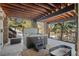 Covered outdoor hot tub area with stone pillars, wooden beams, and scenic views of nature at 3064 Elk View Dr, Evergreen, CO 80439