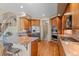 Bright kitchen featuring granite counters, stainless appliances, bar seating and an iron staircase at 3064 Elk View Dr, Evergreen, CO 80439
