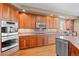 Spacious kitchen featuring stainless steel appliances, granite countertops, and wood floors at 3064 Elk View Dr, Evergreen, CO 80439