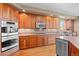 Well-appointed kitchen features wood cabinets, granite countertops, stainless steel appliances and lots of natural light at 3064 Elk View Dr, Evergreen, CO 80439