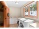 Laundry room with washer and dryer, a sink, and a window at 3064 Elk View Dr, Evergreen, CO 80439