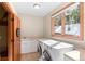 Well-equipped laundry room with modern appliances and a functional layout and window at 3064 Elk View Dr, Evergreen, CO 80439