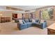 Spacious living room with a cozy sectional sofa, a pool table, and bright windows with outside views at 3064 Elk View Dr, Evergreen, CO 80439