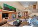Spacious living room featuring a fireplace, hardwood floors, and seamless transition to the upper level at 3064 Elk View Dr, Evergreen, CO 80439