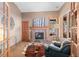 Living room with a fireplace, leather chair, and a faux cowhide rug at 3064 Elk View Dr, Evergreen, CO 80439
