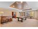 Open living area features a pool table, a rustic wet bar with stools, and bright windows with outside views at 3064 Elk View Dr, Evergreen, CO 80439