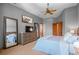 Main bedroom featuring ceiling fan, neutral decor, and a king-sized bed at 3064 Elk View Dr, Evergreen, CO 80439
