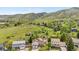 Picturesque aerial view of a home nestled amidst lush greenery and rolling hills at 229 Berthoud Way, Golden, CO 80401