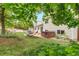 Picturesque backyard featuring a hammock, hot tub, lush greenery, and a meticulously maintained lawn at 229 Berthoud Way, Golden, CO 80401